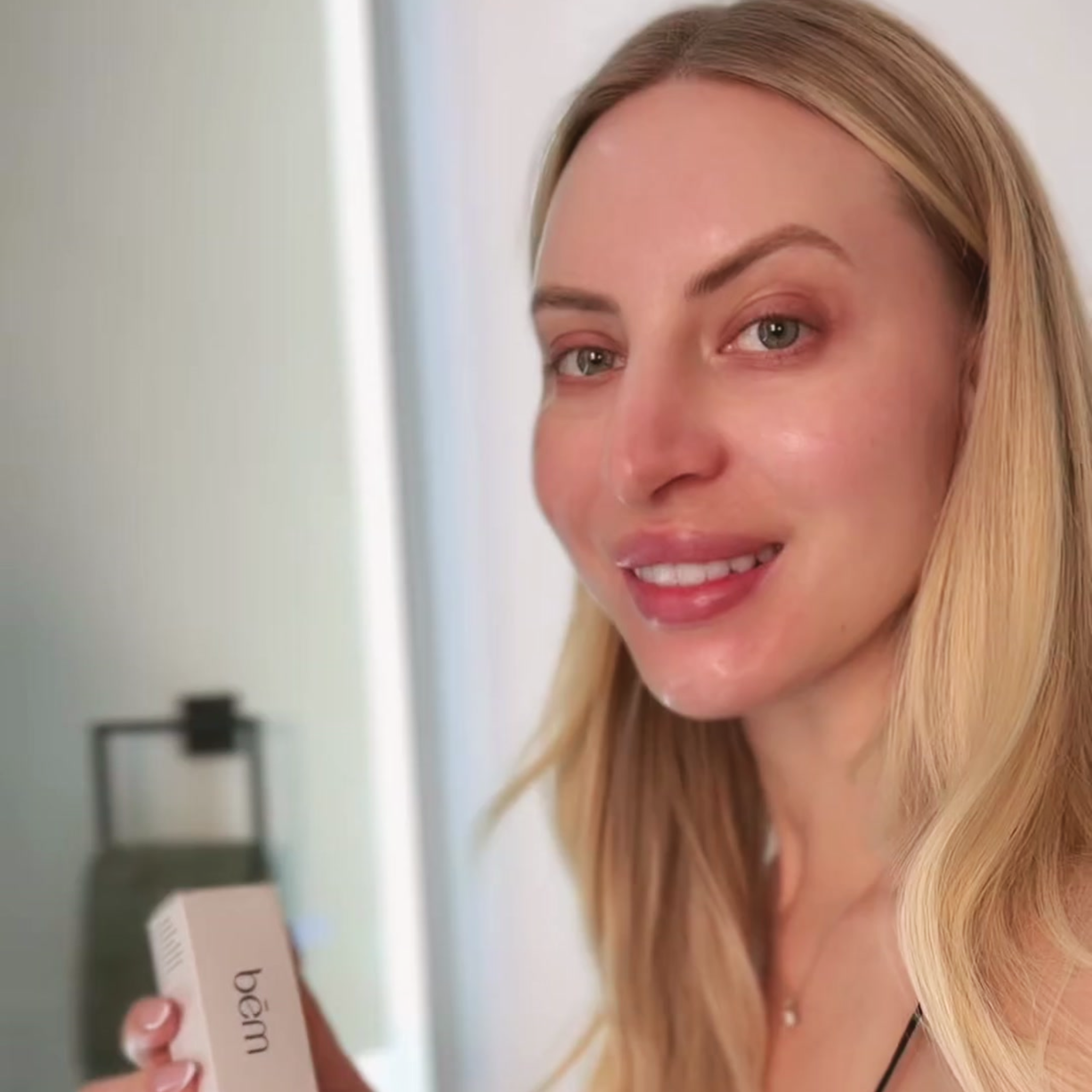 Woman holding a serum box with a blurred background