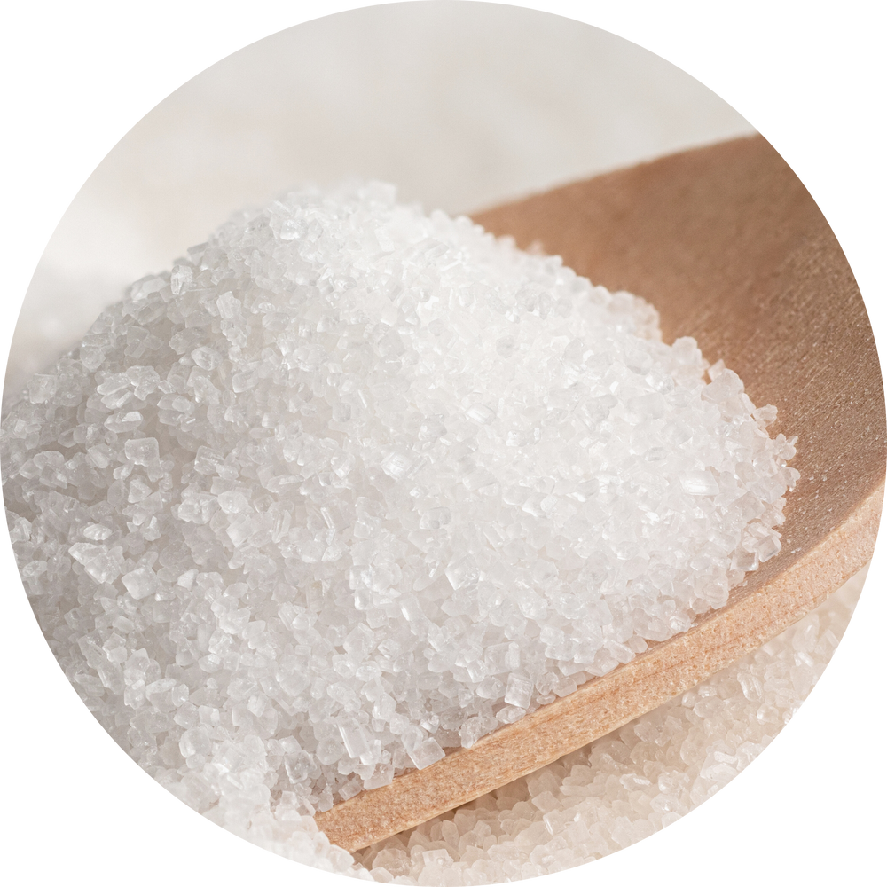 Close-up of sugar granules on a wooden spoon