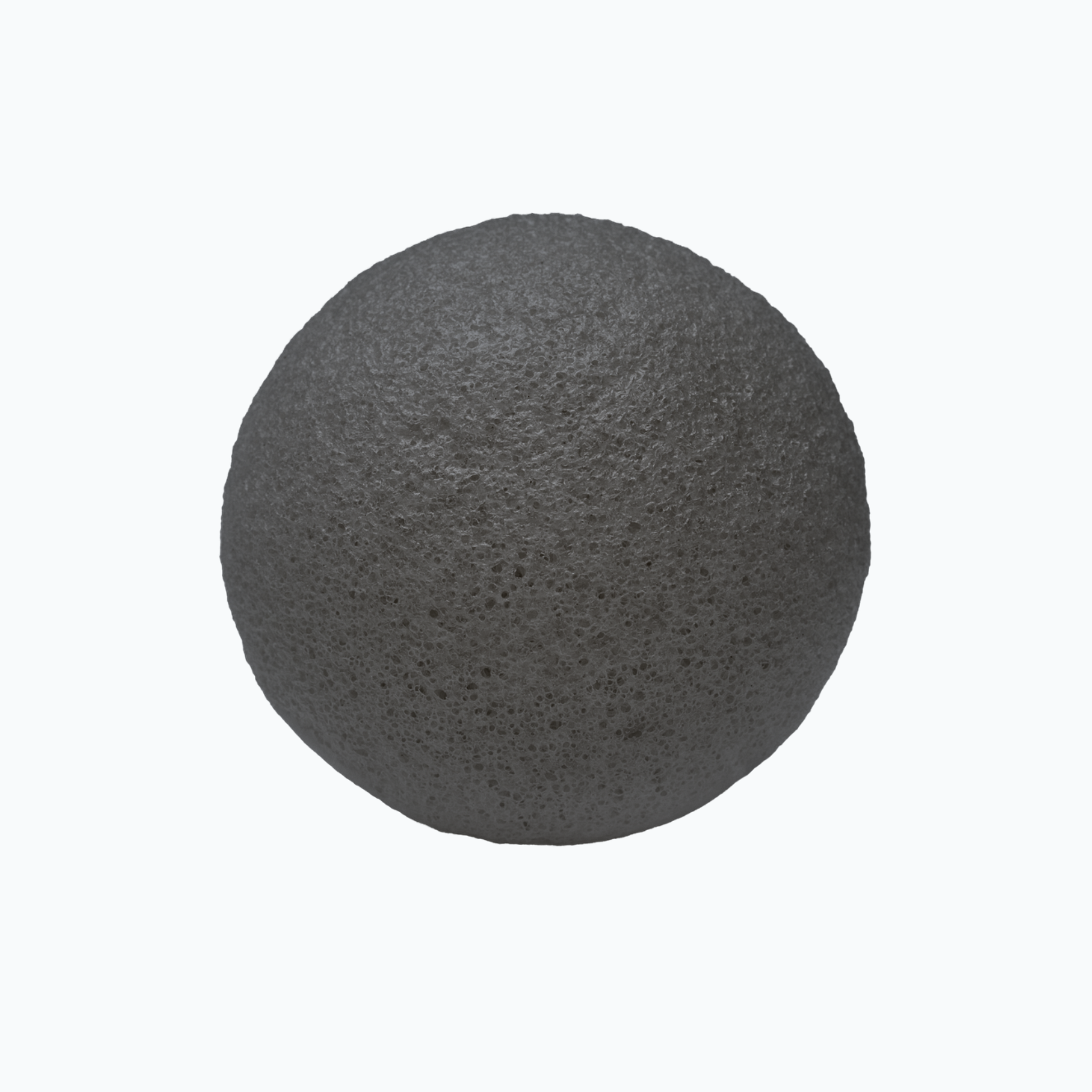 Charcoal konjac sponge on a white background.