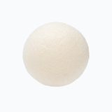 Round konjac facial sponge on a neutral 
background