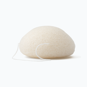 Konjac facial sponge with string on a neutral background