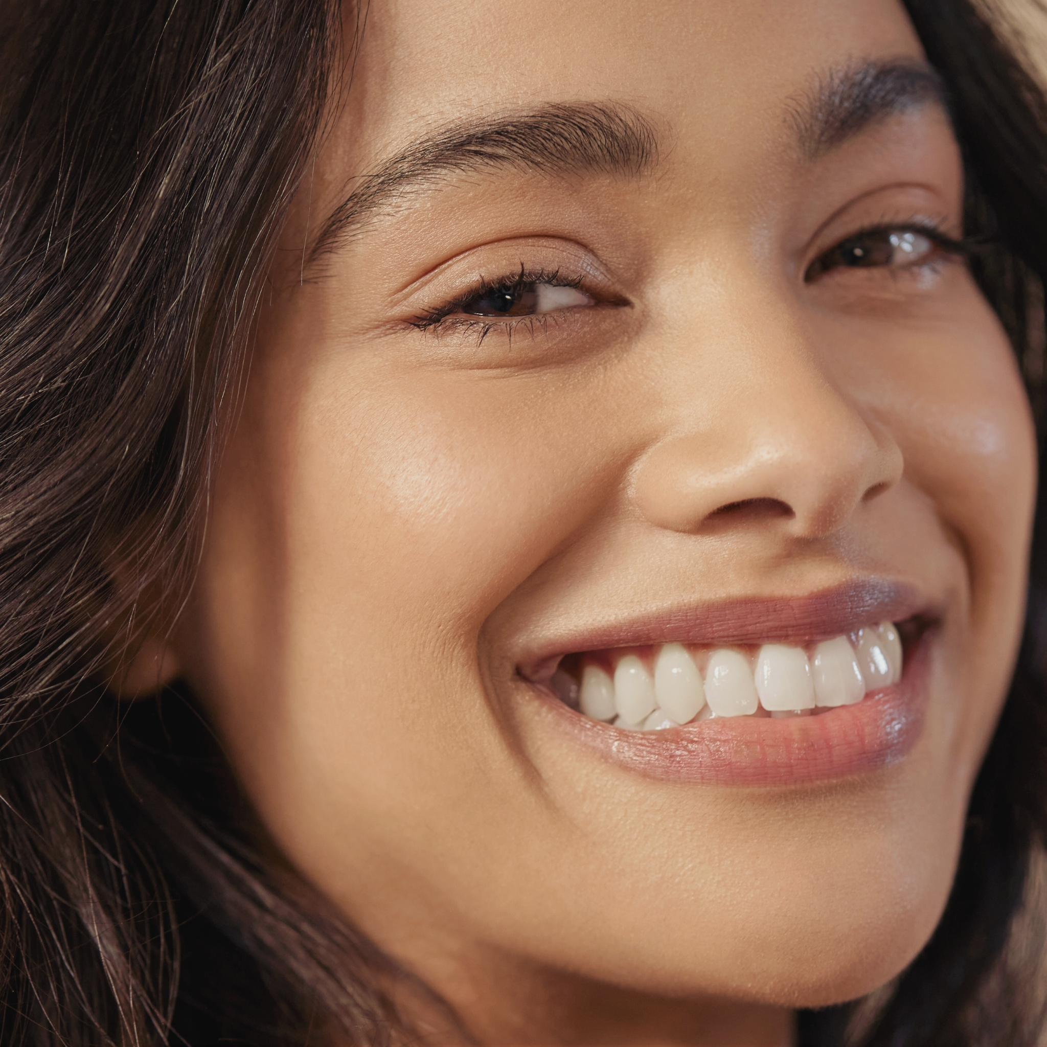Close-up of a woman smiling with a soft focus background