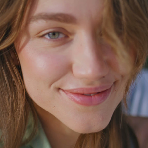 woman smiling with sunlight on her face