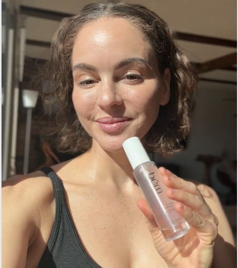 woman showing serums and skin while giving testimonial